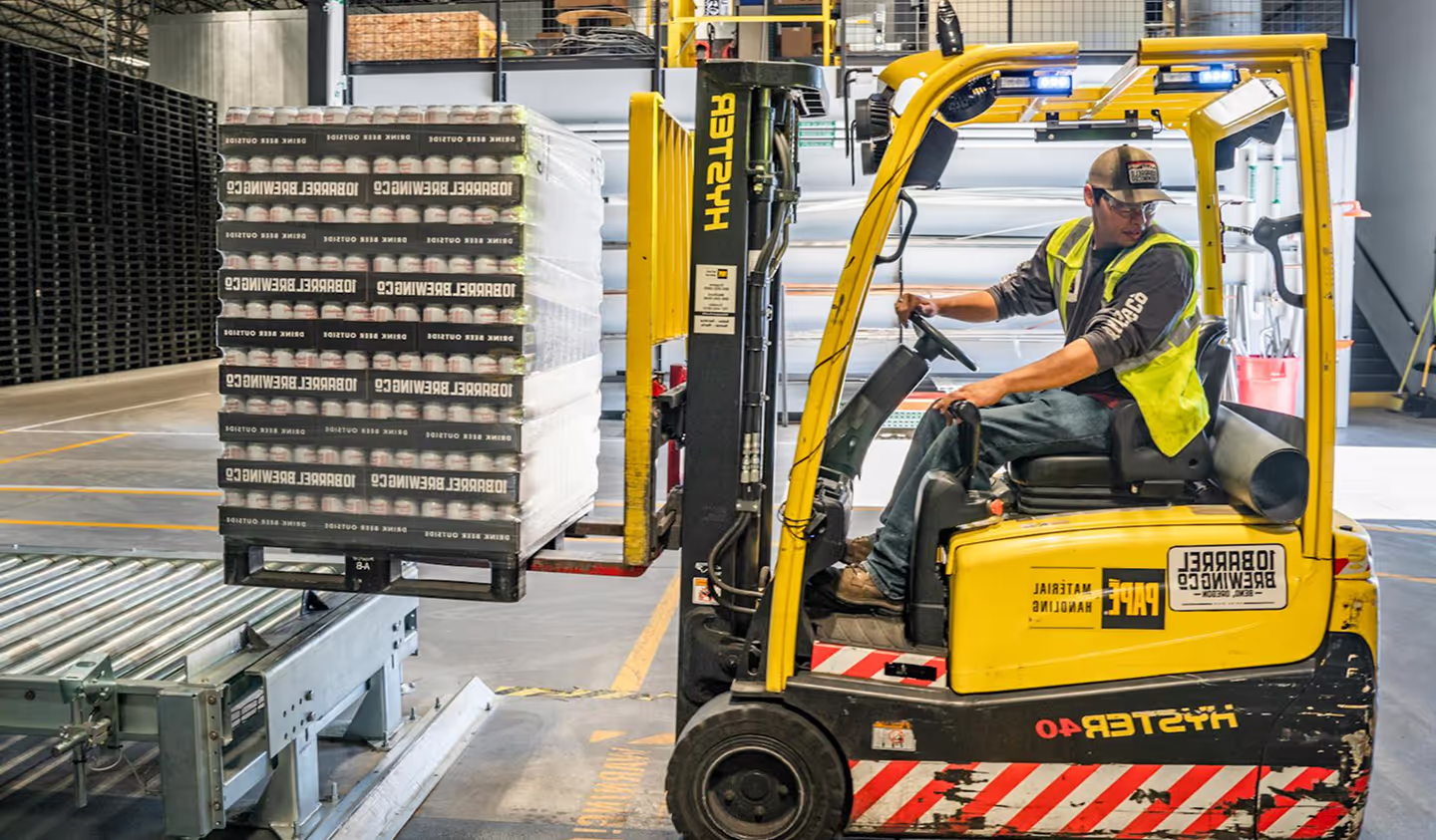 Man working at Bora Industries on a forklift.
